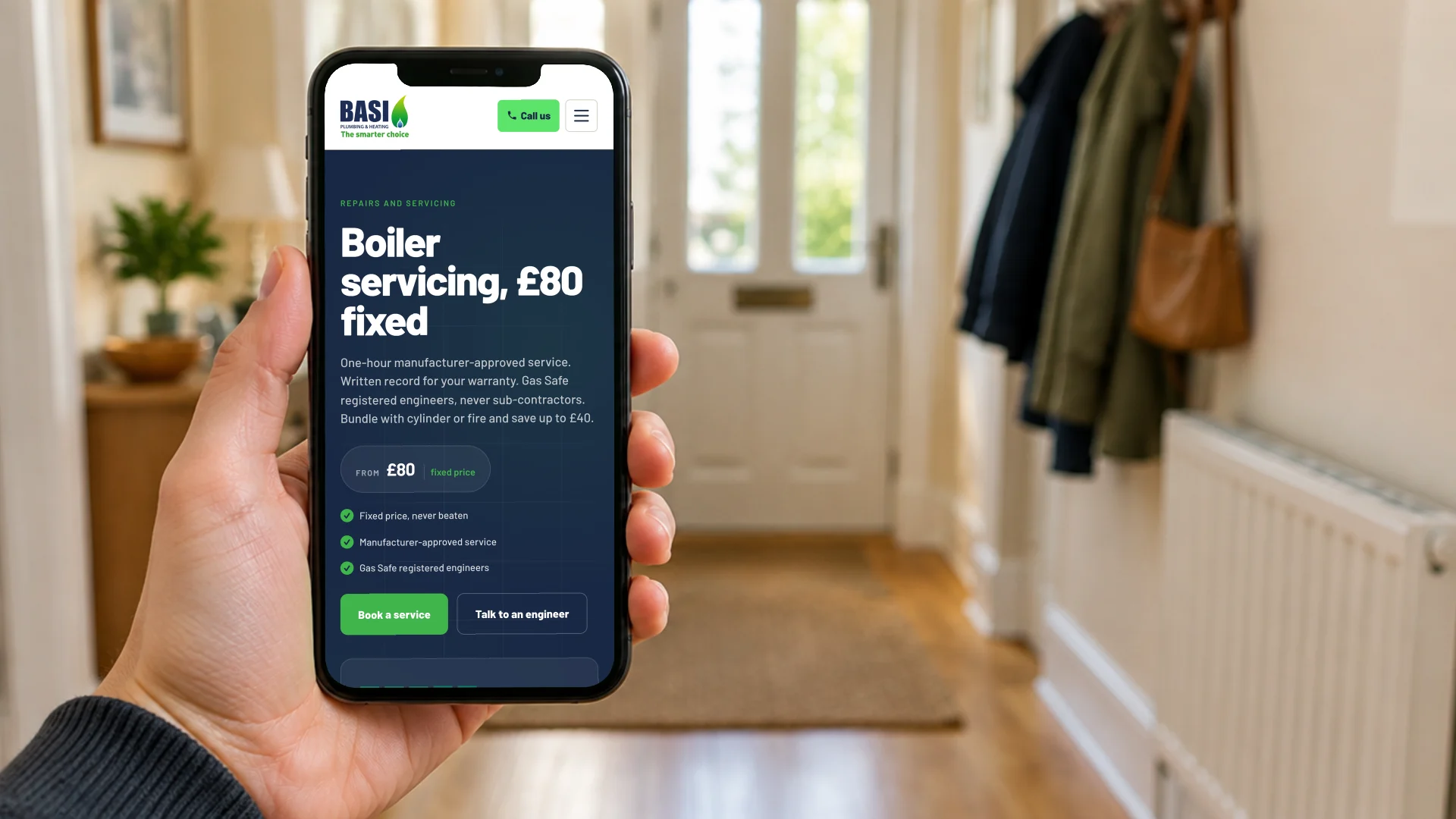 A hand holding a phone in a home hallway beside a radiator, showing the BASI Heating boiler servicing page with its £80 fixed price and Book a service button